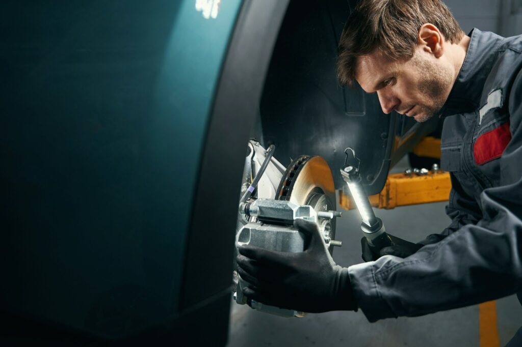 Male doing inspection of the brake system