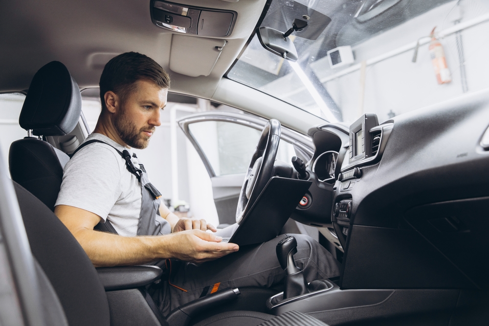 Mechanic performing computer diagnostics