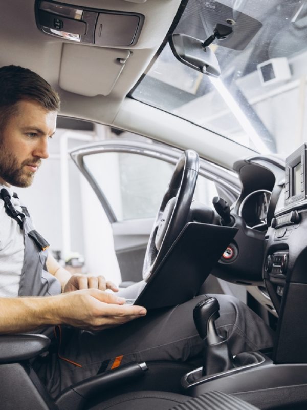 Mechanic performing computer diagnostics