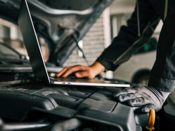 Mechanic performing computer diagnostics