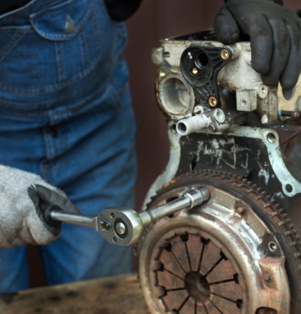 Duggy's Garage technician repairing car clutch