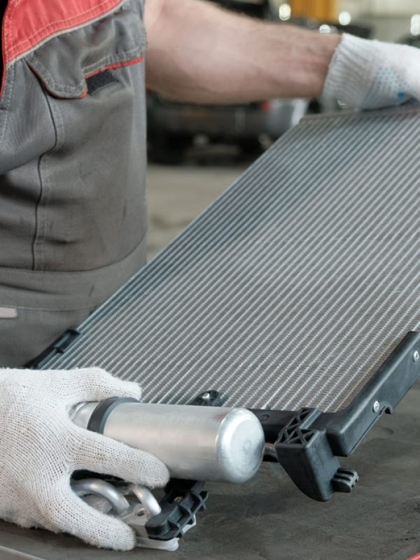 mechanic holding a car radiator