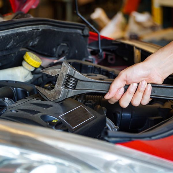 car mechanic holding a wrench for vehicle repair