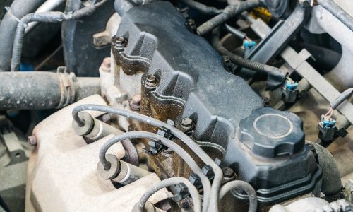 Oil leaks from under the valve cover of an internal combustion engine.