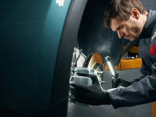Male doing inspection of the brake system